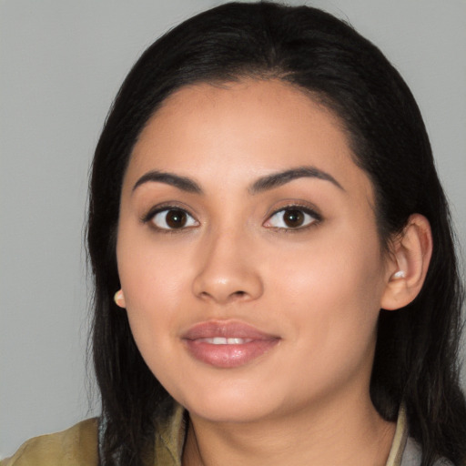 Joyful latino young-adult female with long  black hair and brown eyes