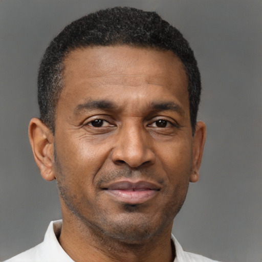 Joyful black adult male with short  black hair and brown eyes