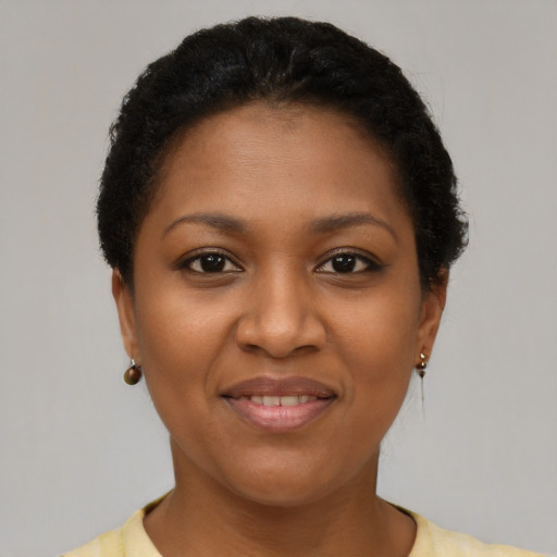 Joyful black young-adult female with short  brown hair and brown eyes