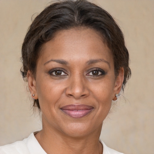 Joyful black adult female with short  brown hair and brown eyes