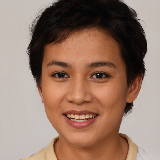 Joyful asian young-adult female with short  brown hair and brown eyes