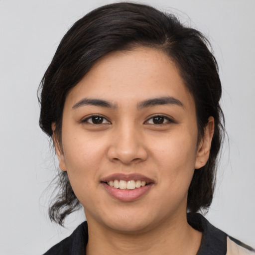 Joyful asian young-adult female with medium  brown hair and brown eyes