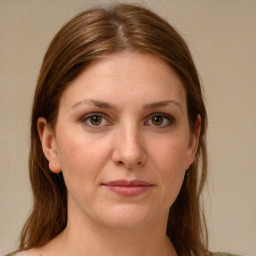 Joyful white young-adult female with medium  brown hair and green eyes