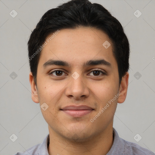 Joyful latino young-adult male with short  brown hair and brown eyes