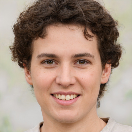 Joyful white young-adult female with short  brown hair and green eyes