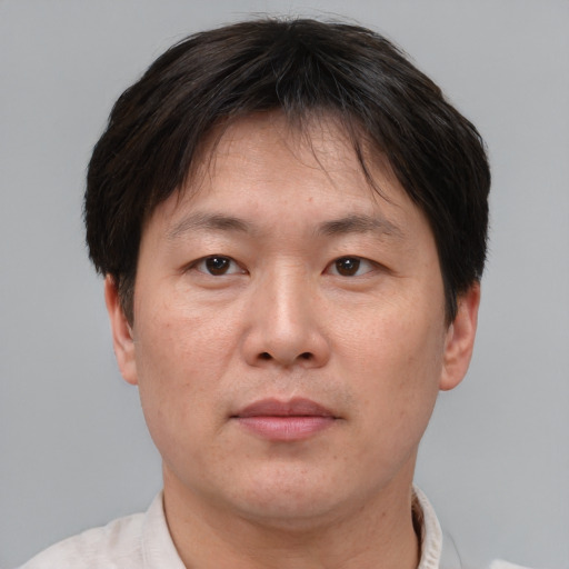 Neutral asian adult male with short  brown hair and brown eyes