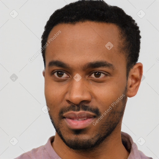 Joyful black young-adult male with short  black hair and brown eyes