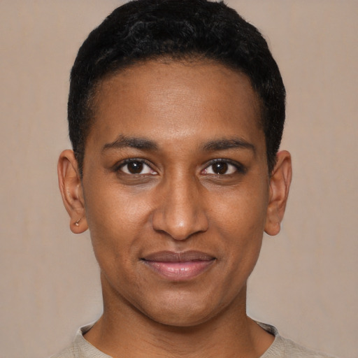Joyful black young-adult male with short  black hair and brown eyes