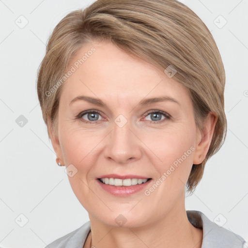 Joyful white adult female with medium  brown hair and grey eyes