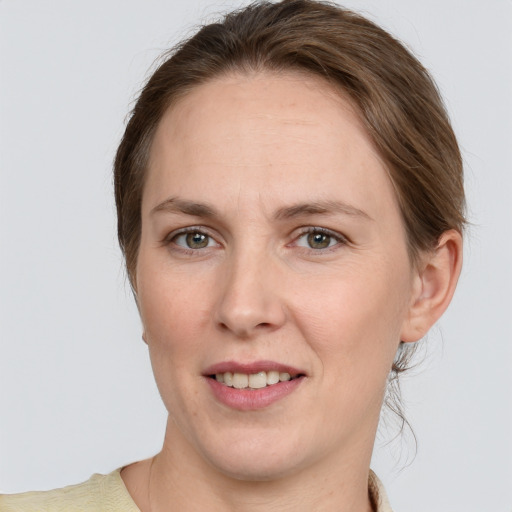 Joyful white adult female with medium  brown hair and grey eyes