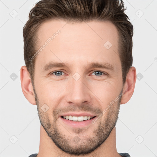 Joyful white young-adult male with short  brown hair and grey eyes