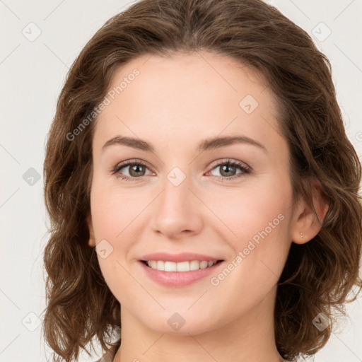 Joyful white young-adult female with long  brown hair and green eyes