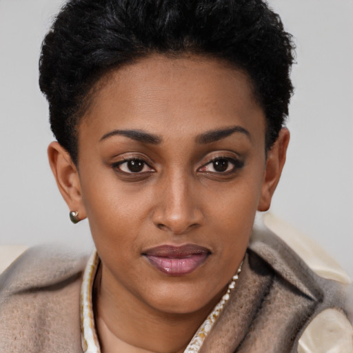Joyful black young-adult female with short  brown hair and brown eyes