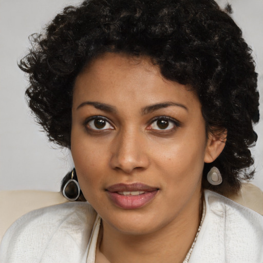 Joyful black young-adult female with medium  brown hair and brown eyes
