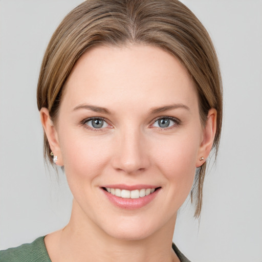 Joyful white young-adult female with medium  brown hair and blue eyes