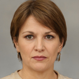 Joyful white adult female with medium  brown hair and grey eyes