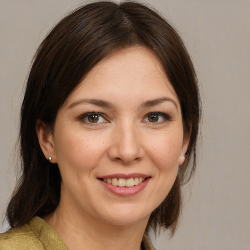 Joyful white young-adult female with medium  brown hair and brown eyes