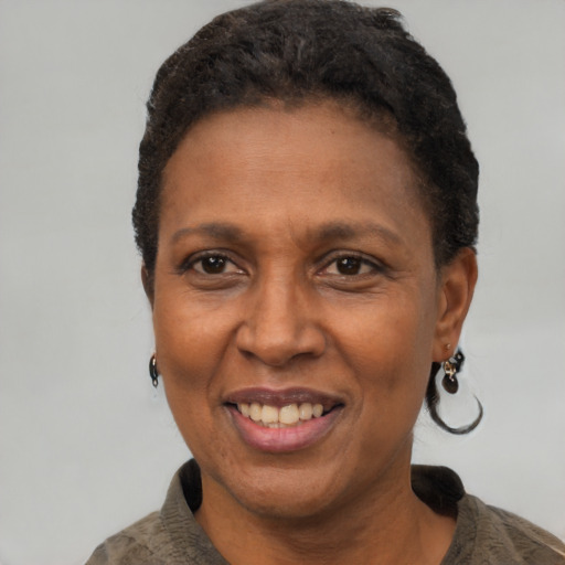 Joyful black adult female with short  black hair and brown eyes