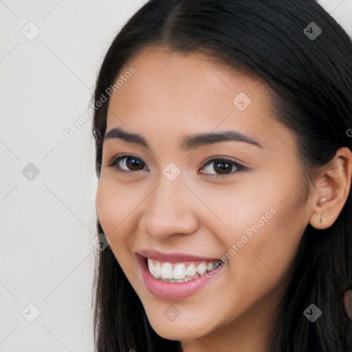 Joyful latino young-adult female with long  black hair and brown eyes