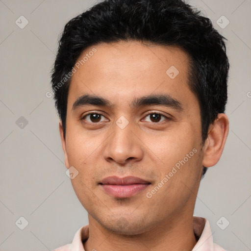 Joyful latino young-adult male with short  black hair and brown eyes