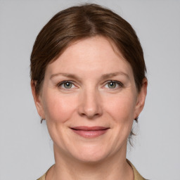 Joyful white adult female with medium  brown hair and grey eyes