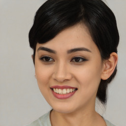 Joyful asian young-adult female with medium  black hair and brown eyes