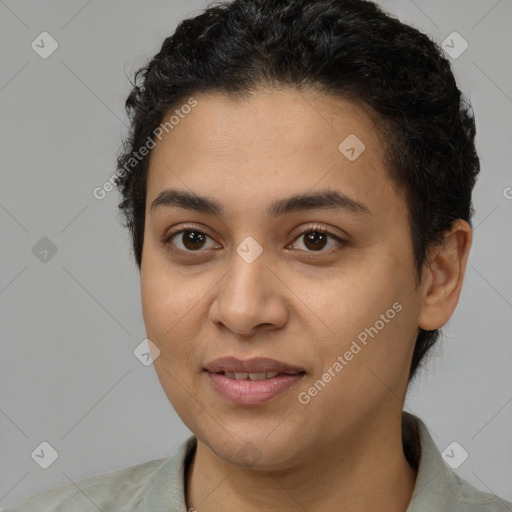 Joyful latino young-adult female with short  black hair and brown eyes