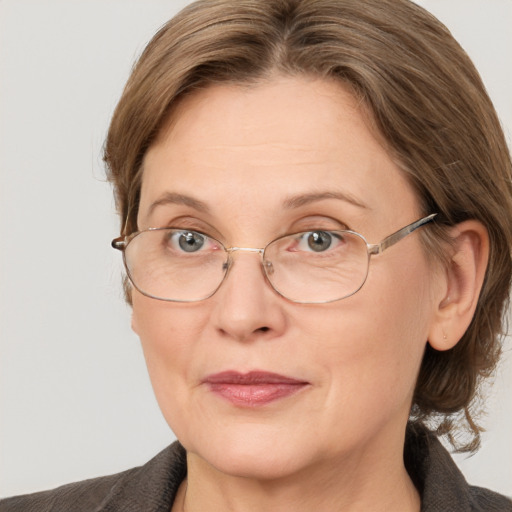 Joyful white adult female with medium  brown hair and grey eyes