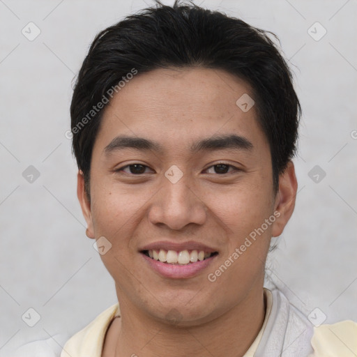 Joyful asian young-adult male with short  brown hair and brown eyes