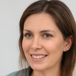 Joyful white young-adult female with medium  brown hair and grey eyes