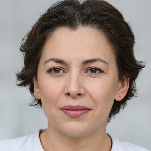 Joyful white adult female with medium  brown hair and brown eyes