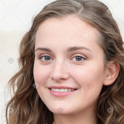 Joyful white young-adult female with long  brown hair and blue eyes