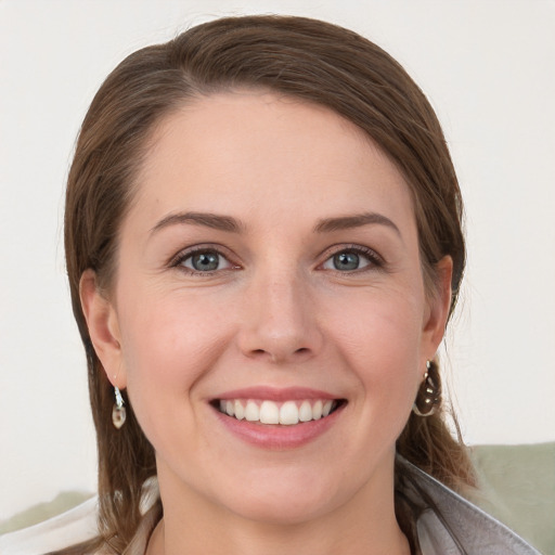 Joyful white young-adult female with long  brown hair and grey eyes