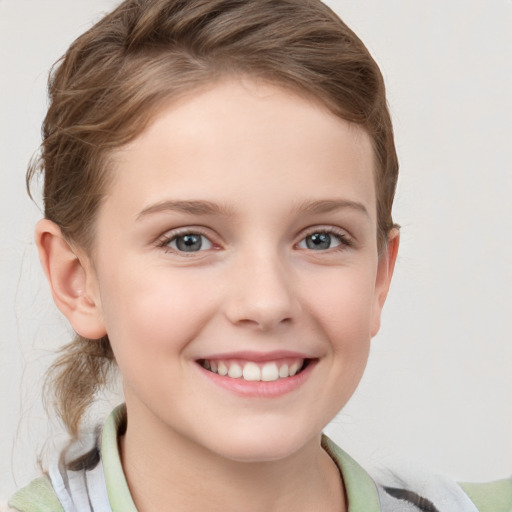 Joyful white child female with short  brown hair and grey eyes