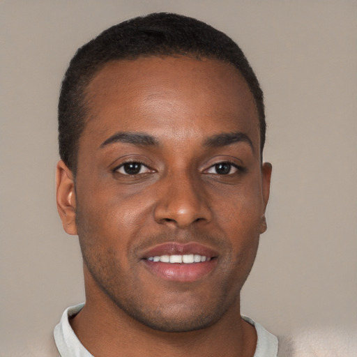 Joyful black young-adult male with short  brown hair and brown eyes