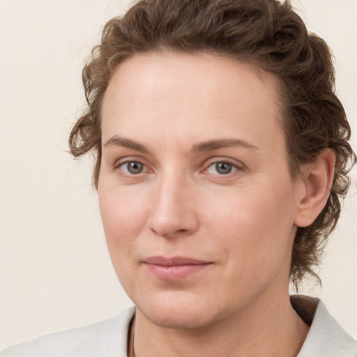 Joyful white young-adult female with medium  brown hair and green eyes