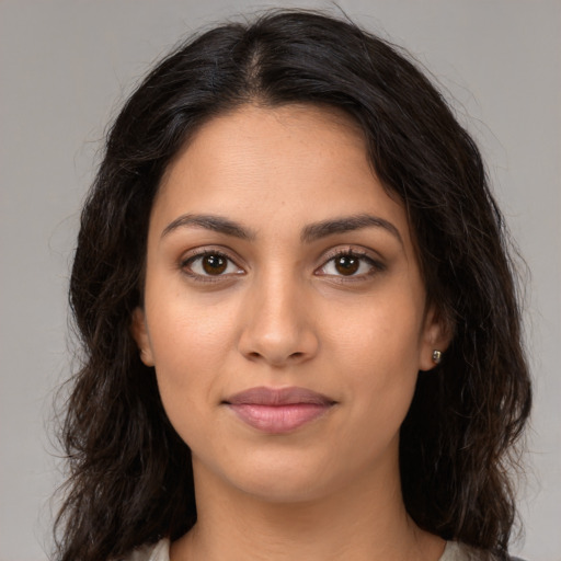 Joyful latino young-adult female with long  brown hair and brown eyes