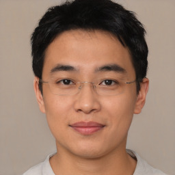 Joyful asian young-adult male with short  black hair and brown eyes