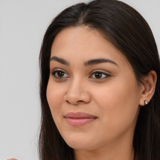 Joyful asian young-adult female with long  brown hair and brown eyes