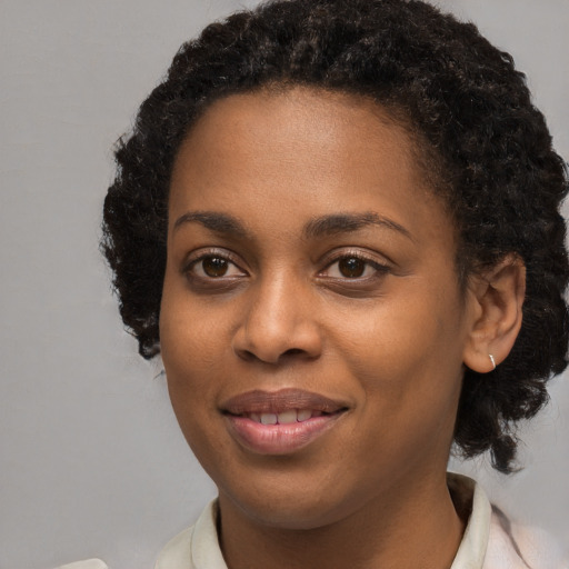 Joyful black young-adult female with medium  brown hair and brown eyes