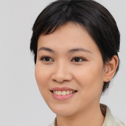 Joyful asian young-adult female with medium  brown hair and brown eyes