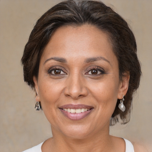 Joyful white adult female with medium  brown hair and brown eyes
