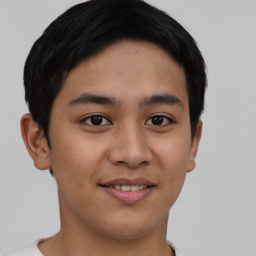Joyful asian young-adult male with short  brown hair and brown eyes