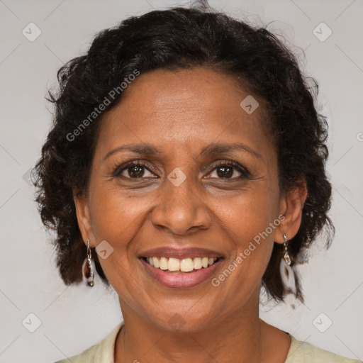 Joyful black adult female with medium  brown hair and brown eyes