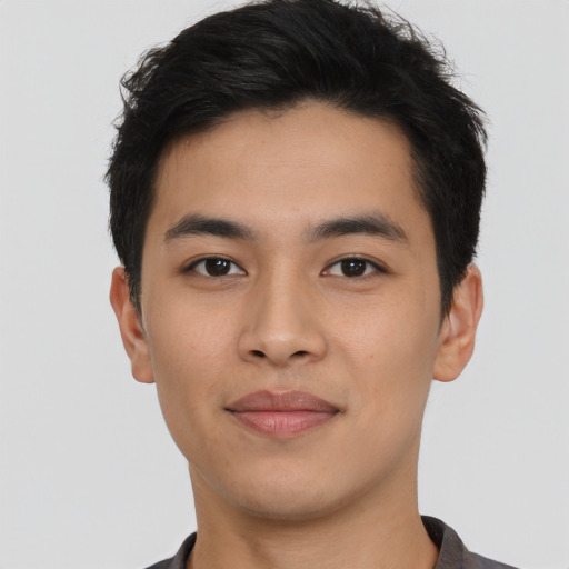 Joyful asian young-adult male with short  black hair and brown eyes