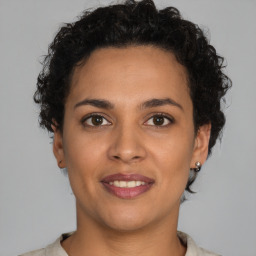 Joyful latino young-adult female with short  brown hair and brown eyes