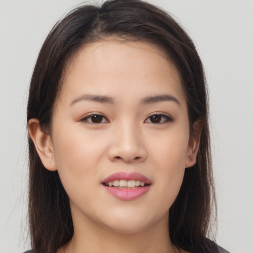 Joyful asian young-adult female with long  brown hair and brown eyes