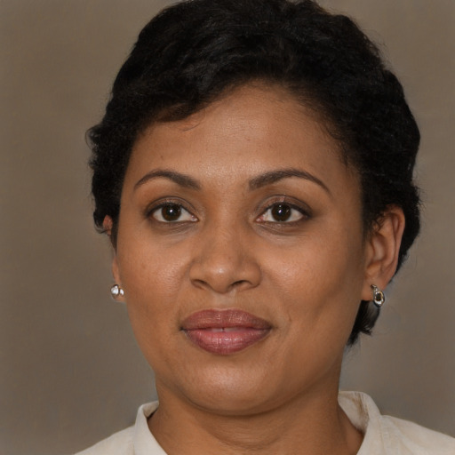 Joyful latino adult female with short  brown hair and brown eyes