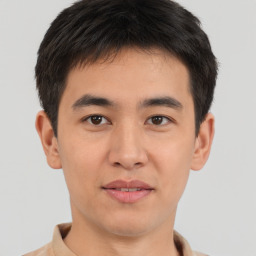 Joyful asian young-adult male with short  brown hair and brown eyes