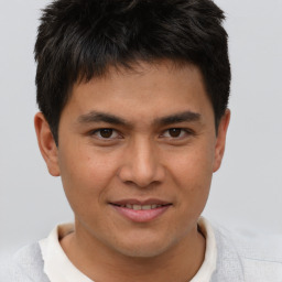 Joyful asian young-adult male with short  brown hair and brown eyes